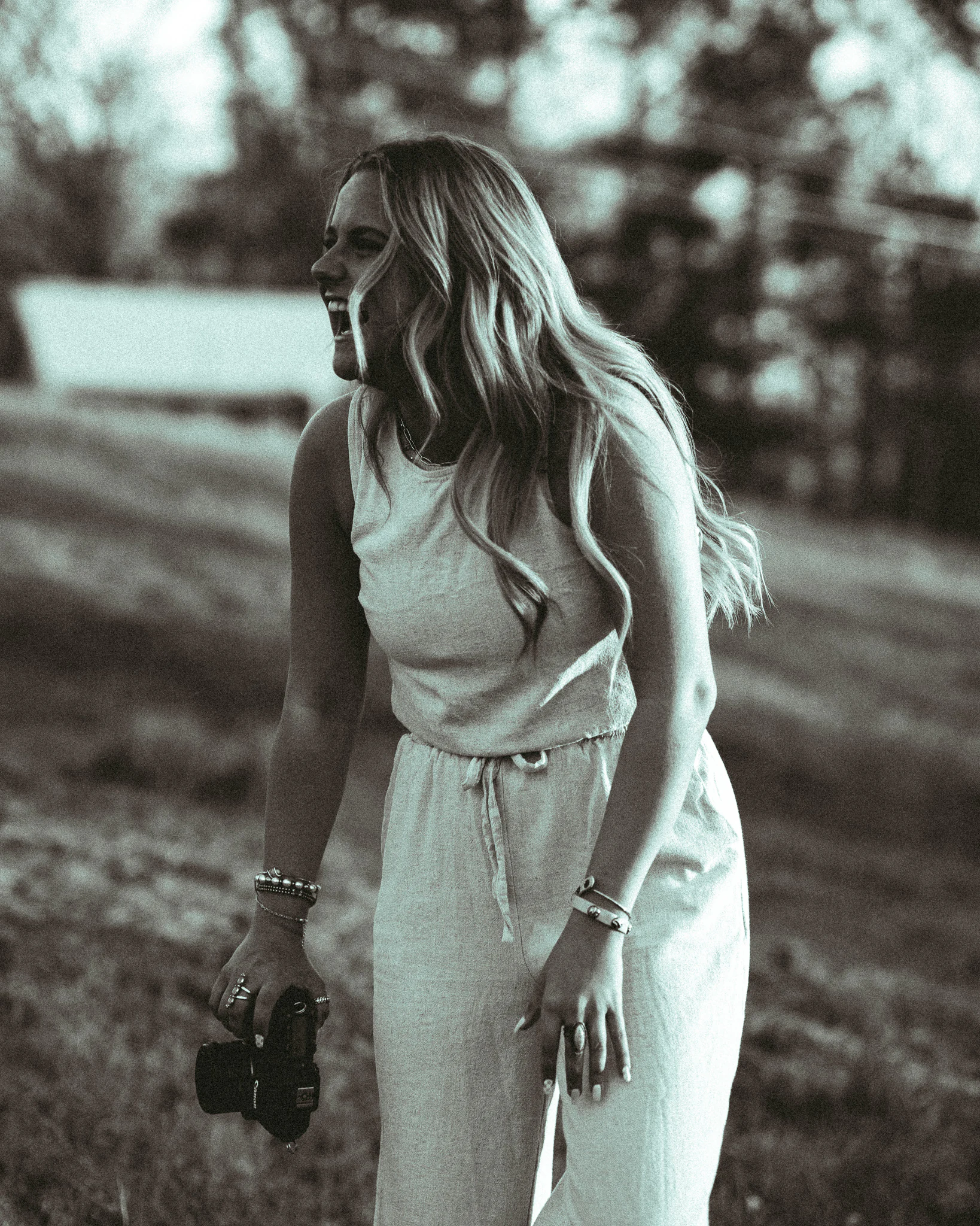Candid black-and-white portrait of Jayda with her camera