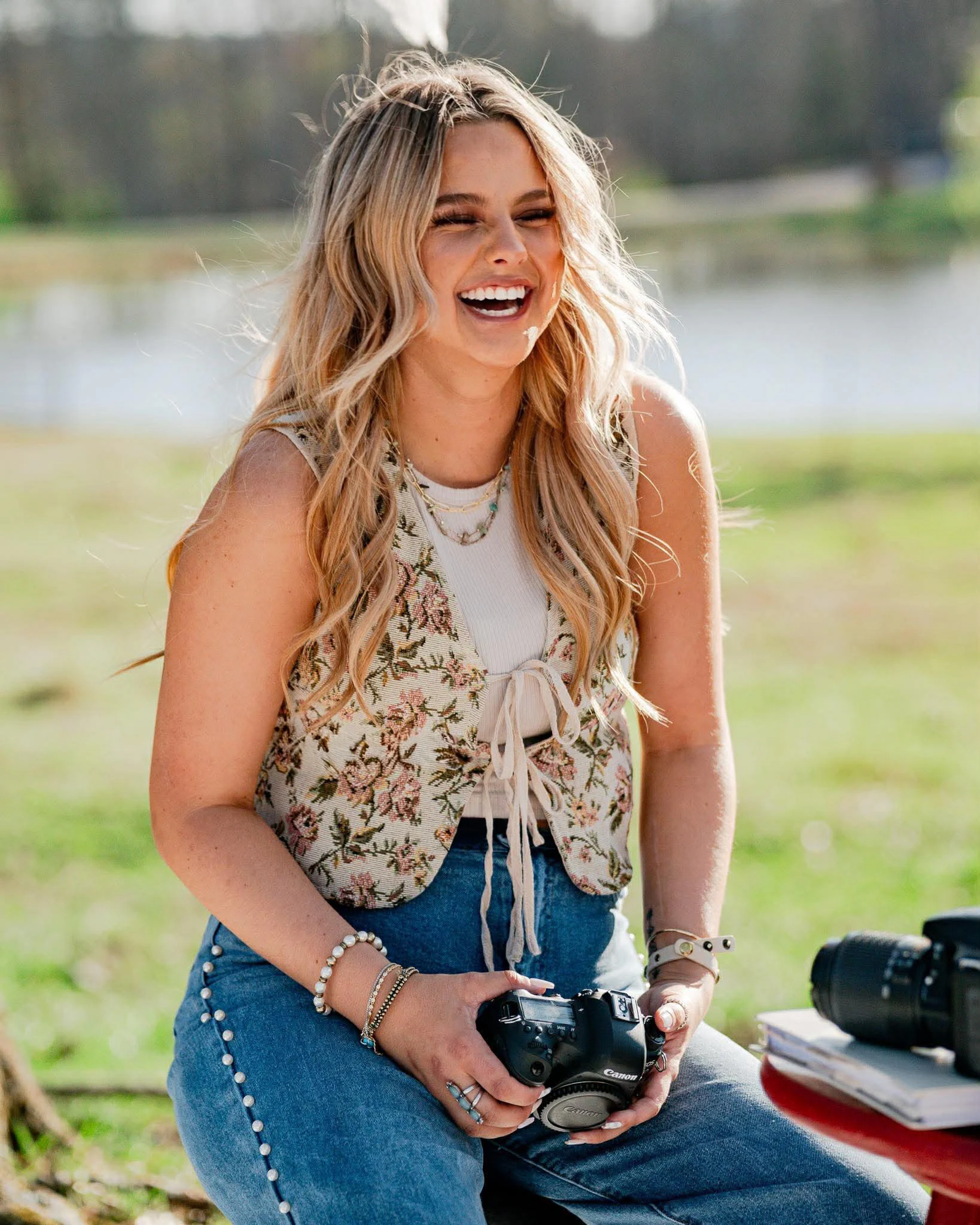 Jayda laughing while seated outdoors